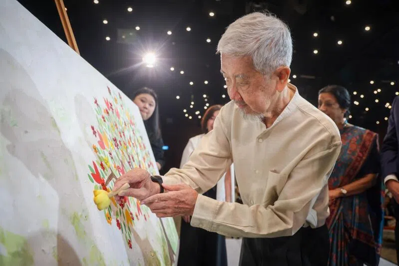  Dr Leong Sai Fan putting the finishing touches on "Where Life Takes Root And Hope Blooms", a collective art tribute at The National University Centre for Organ Transplantation on March 27. 