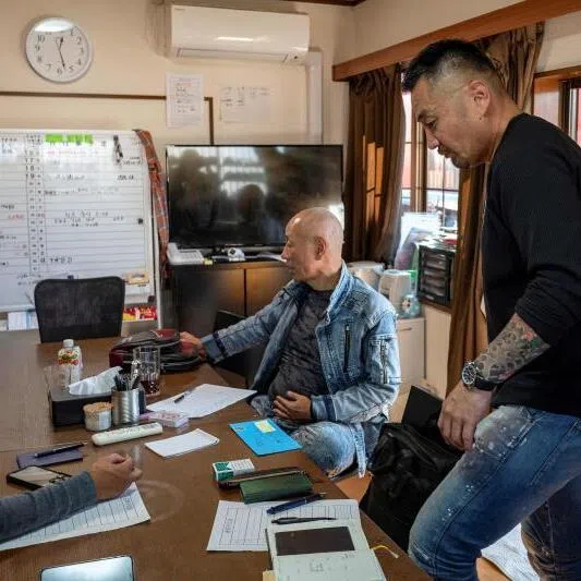 Former gangster Yoshiro Nishino (right) discussing management with residents of his group home for ex-offenders in Chiba Prefecture on Nov 7.