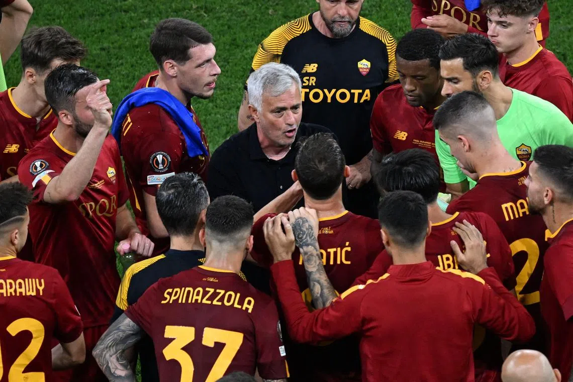 AS Roma's Portuguese coach Jose Mourinho speaks with his players ahead of the second half of extra-time during the UEFA Europa League final between Sevilla FC and AS Roma on May 31, 2023. (Photo by Ferenc ISZA / AFP)