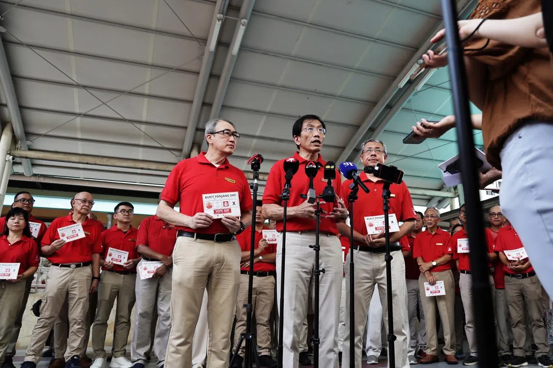 SDP secretary-general Chee Soon Juan (centre) with Sembawang GRC candidates Alfred Tan (left) and Damanhuri Abas at the SDP slogan launch on April 19.
