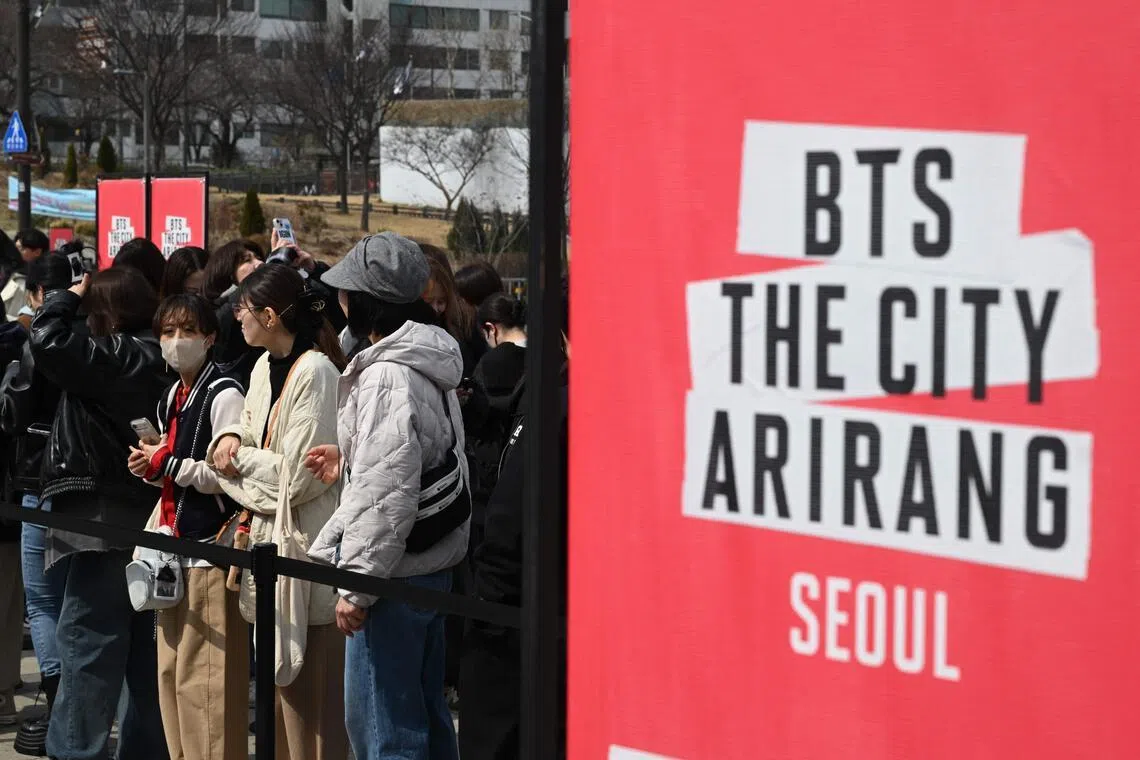 BTS fans wait in a line to enter a fan zone promoting the new album of K-pop boy band BTS at a riverside park in Seoul on March 20.