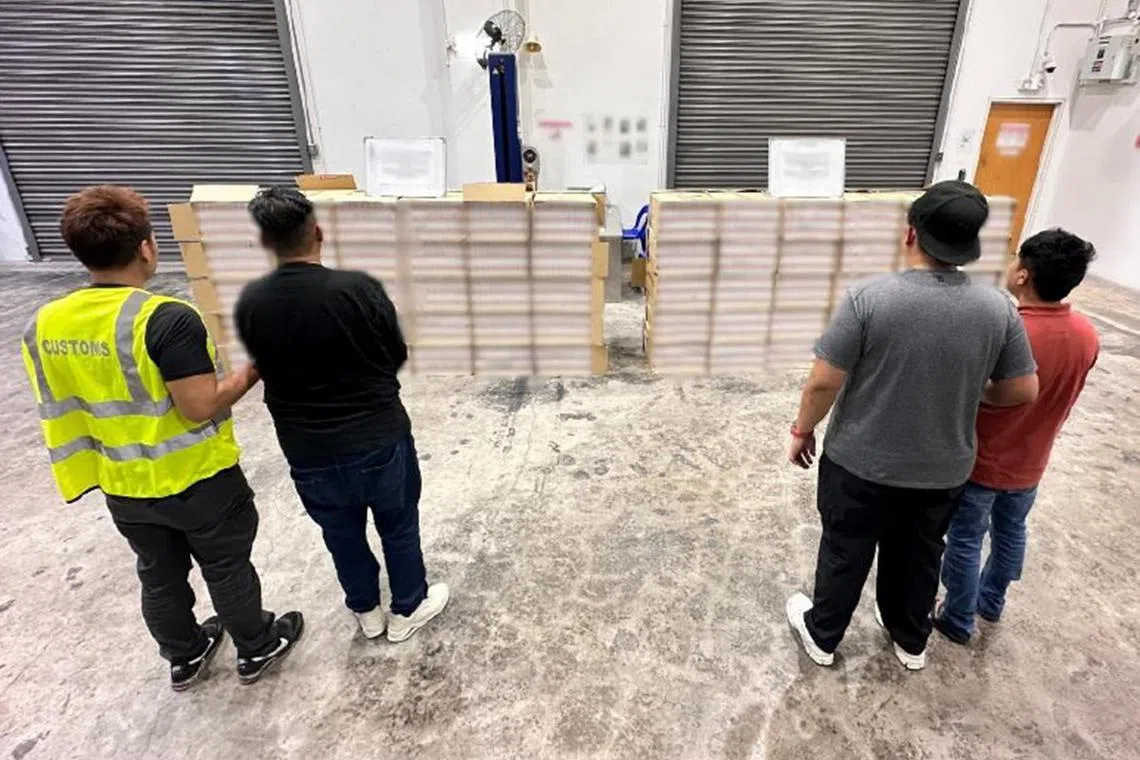 iccig06 - Two of the men arrested and the duty-unpaid cigarettes seized.


Credit: Singapore Customs