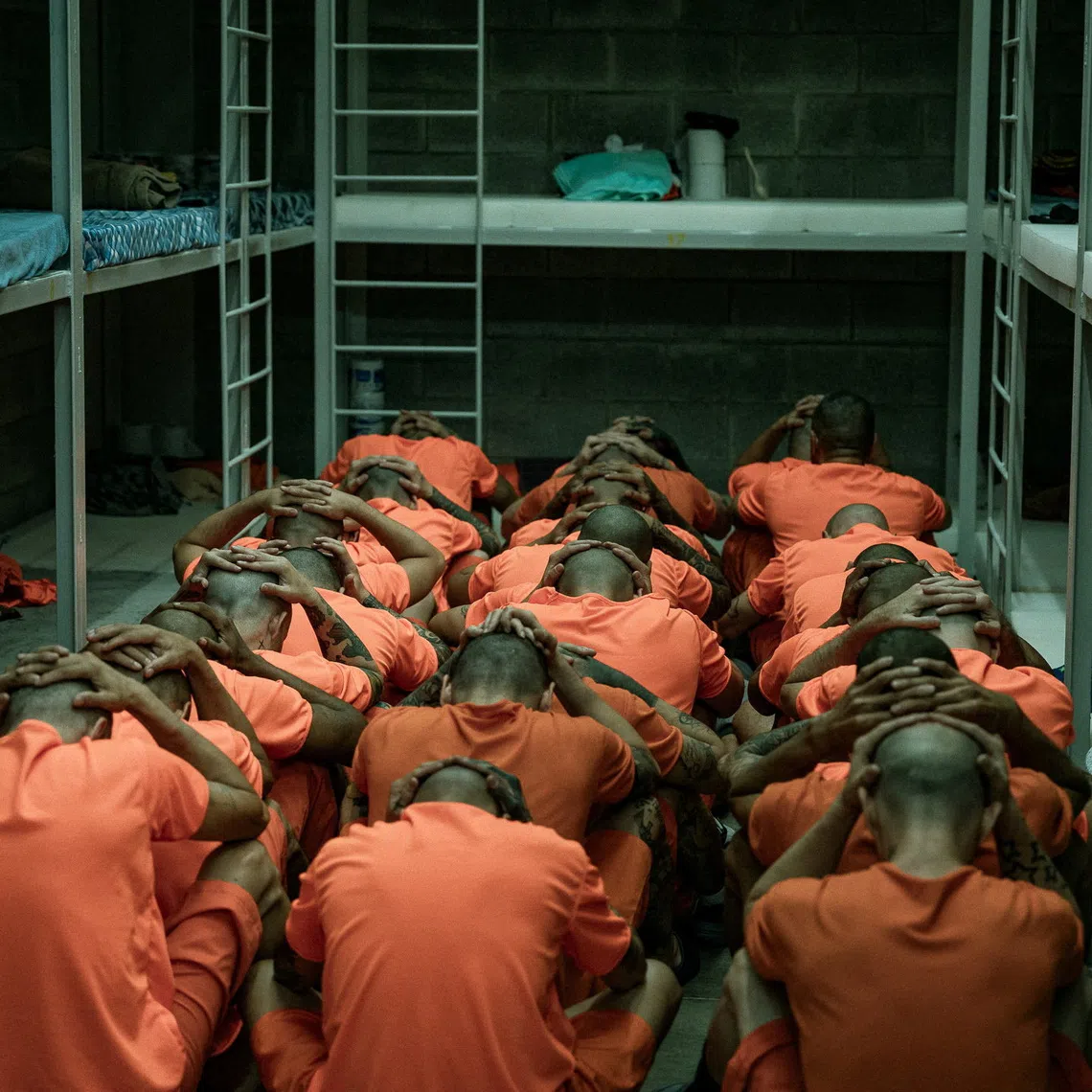 Inmates sit on the floor with their hands on their heads inside a cell following their transfer to the Center for High Containment of Organized Crime (CACCO), a new maximum-security prison built in cooperation with the government of El Salvador President Nayib Bukele, in Alajuela, Costa Rica, in this handout image distributed on October 27, 2026. Ministerio de Justicia y Paz/Handout via REUTERS ATTENTION EDITORS - THIS IMAGE HAS BEEN SUPPLIED BY A THIRD PARTY. NO RESALES. NO ARCHIVES