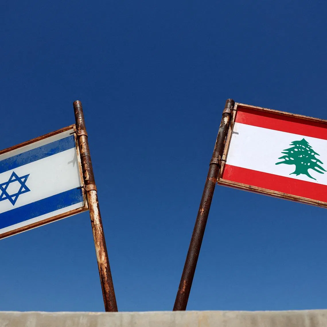 FILE PHOTO: Representations of the Israeli and Lebanese flags at a memorial near the Israel-Lebanon border, outside Metula, Israel, June 27, 2026, after Israel and Lebanon signed a framework agreement following U.S.-mediated talks. REUTERS/Amir Cohen/File Photo