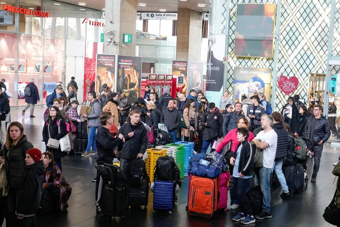Passengers wait inside Termini train station after train services in Italy were disrupted during the Olympics, in Rome on Feb 14.