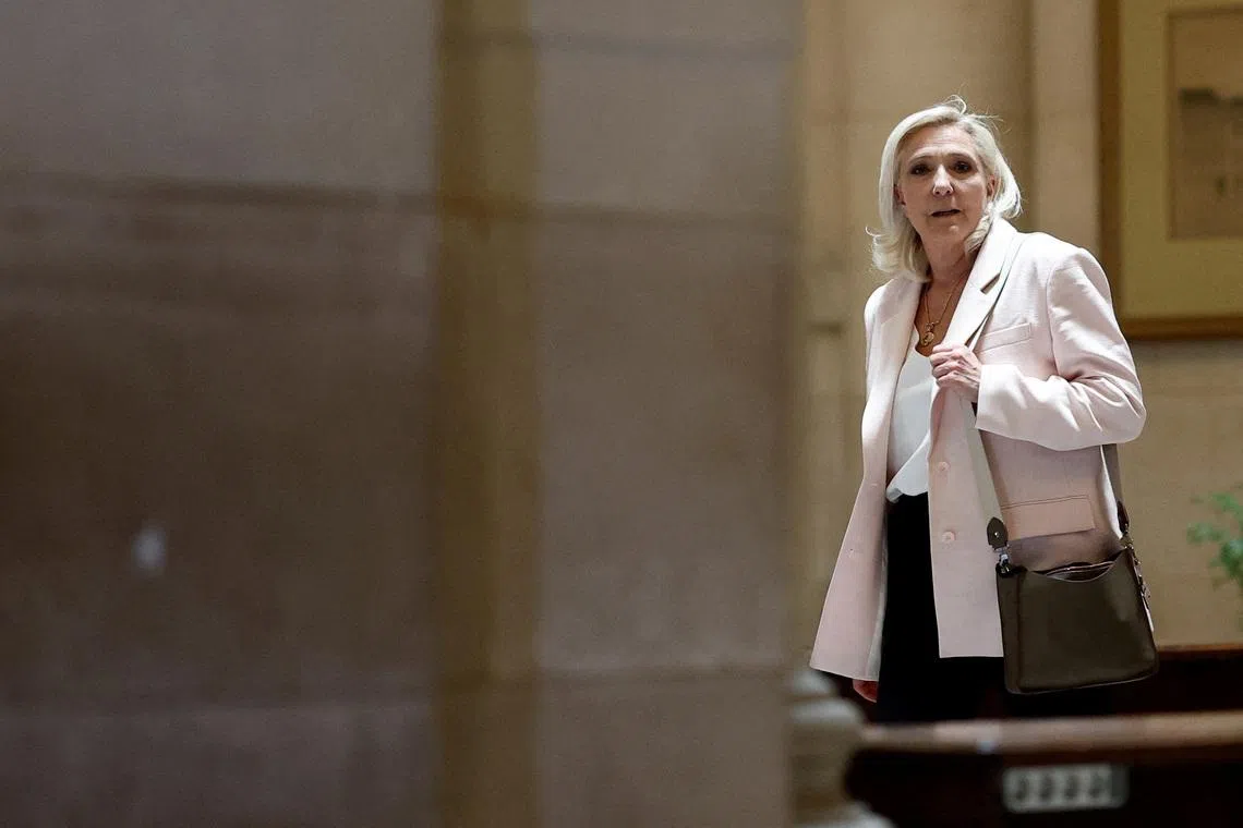 French far-right leader Marine Le Pen, member of parliament for the Rassemblement National (National Rally - RN) party, leaves after the verdict in her appeal trial, alongside the RN party itself and 10 others defendants found guilty of diverting European Parliament funds, at the Paris courthouse on the Ile de la Cite, in Paris, France, July 7, 2026. REUTERS/Benoit Tessier