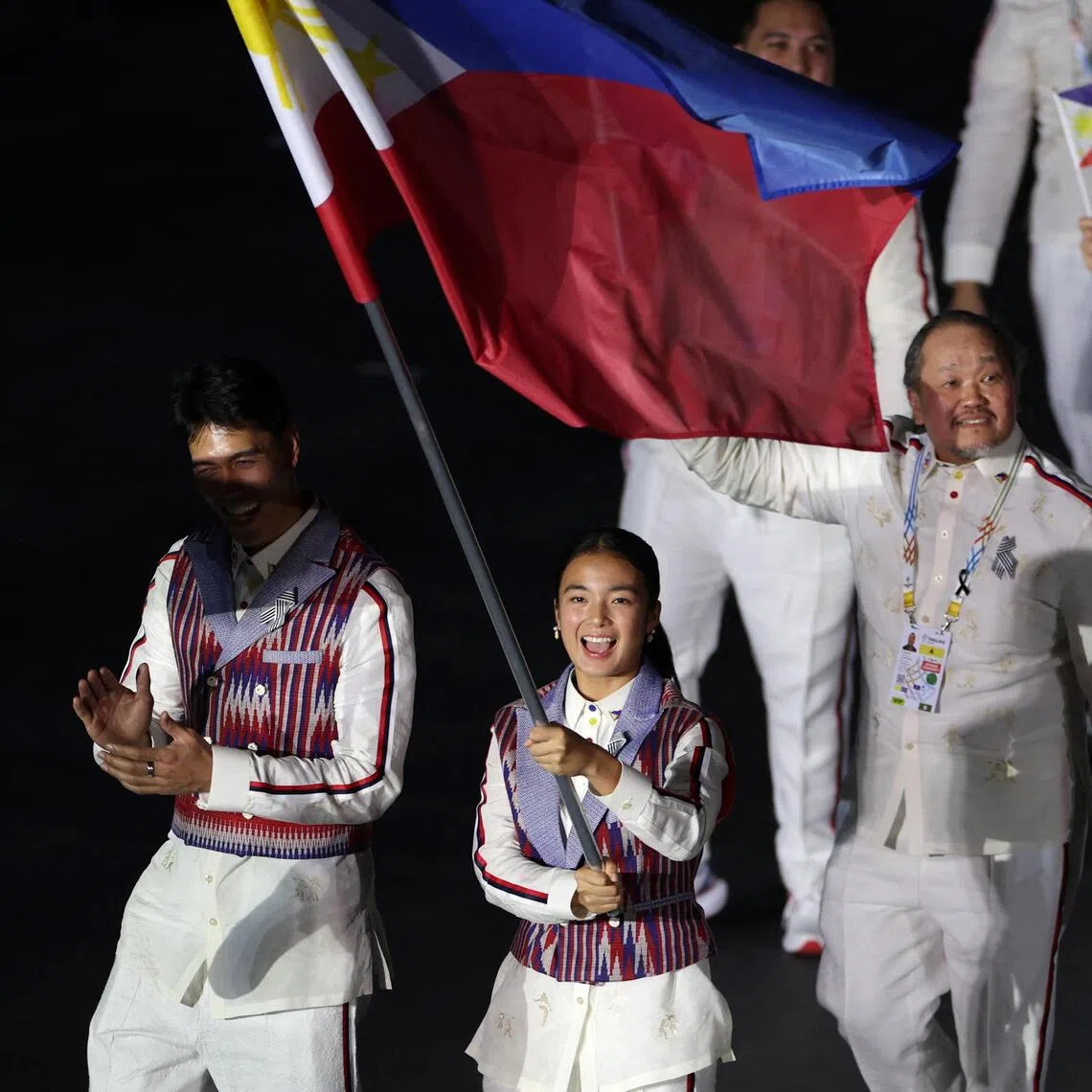 Philippine flag bearers Bryan Bagunas (left) and Alexandra Eala at the opening ceremony of the SEA Games in Bangkok on Dec 9.