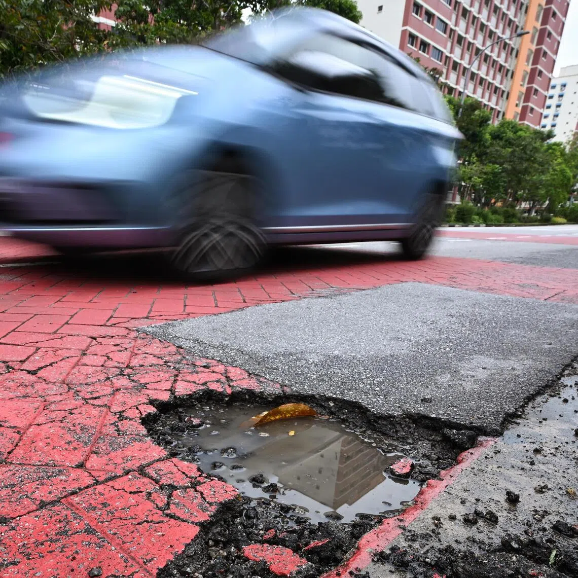 ST20250115-202502800604-Lim Yaohui-pixgeneric/
Pothole outside Poi Ching School along Tampines Street 71 on Jan 15, 2025.
Nearly 100 potholes were detected in the first 12 days of 2025 amid prolonged rainfall across Singapore, though overall annual figures have seen a significant dip in recent years. The Land Transport Authority (LTA) noted that the close to 100 potholes detected from Jan 1 to 12 is still fewer than the 776 potholes found during the same period in 2024.
Cracks form on road surfaces as part of normal wear and tear, and they are usually repaired as part of LTA’s regular inspection, maintenance and road resurfacing works. Potholes form when water seeps into these cracks and widen as vehicles travel over them.
(ST PHOTO: LIM YAOHUI)