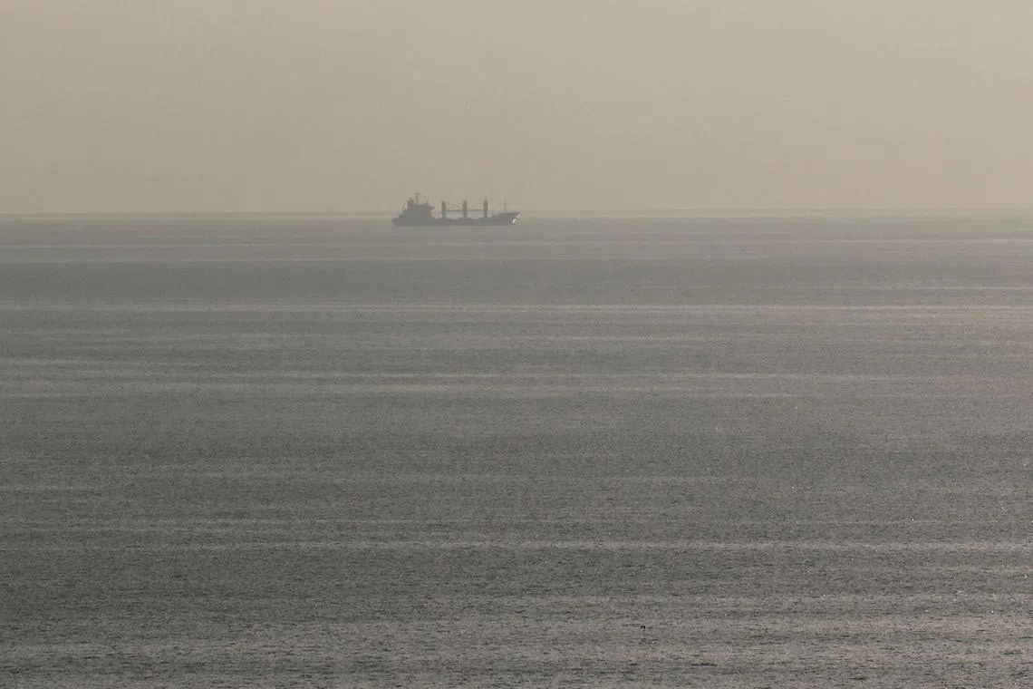 This photograph taken on September 22, 2023, shows the Aroyat vessel carrying 17,600 tons of grain, leaving the Black Sea Ukrainian port of Chornomorsk, Odesa region. A ship carrying wheat has left a Ukrainian port and was heading to Egypt, the second such trip since Russia reimposed its Black Sea blockade in July, Ukraine's Infrastructure Minister said on social media. (Photo by STRINGER / AFP)