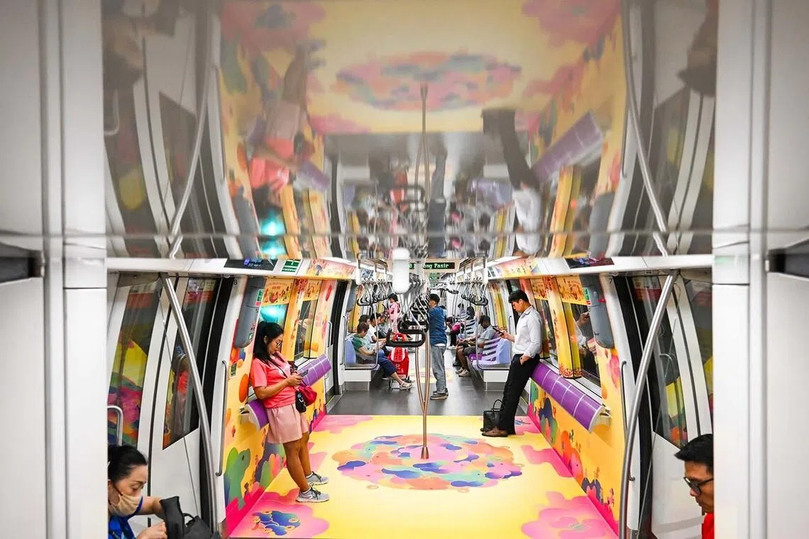 Commuters in Singapore on a Chinese New Year themed train with designs inspired by the Year of the Horse, on Jan 27, 2027. 