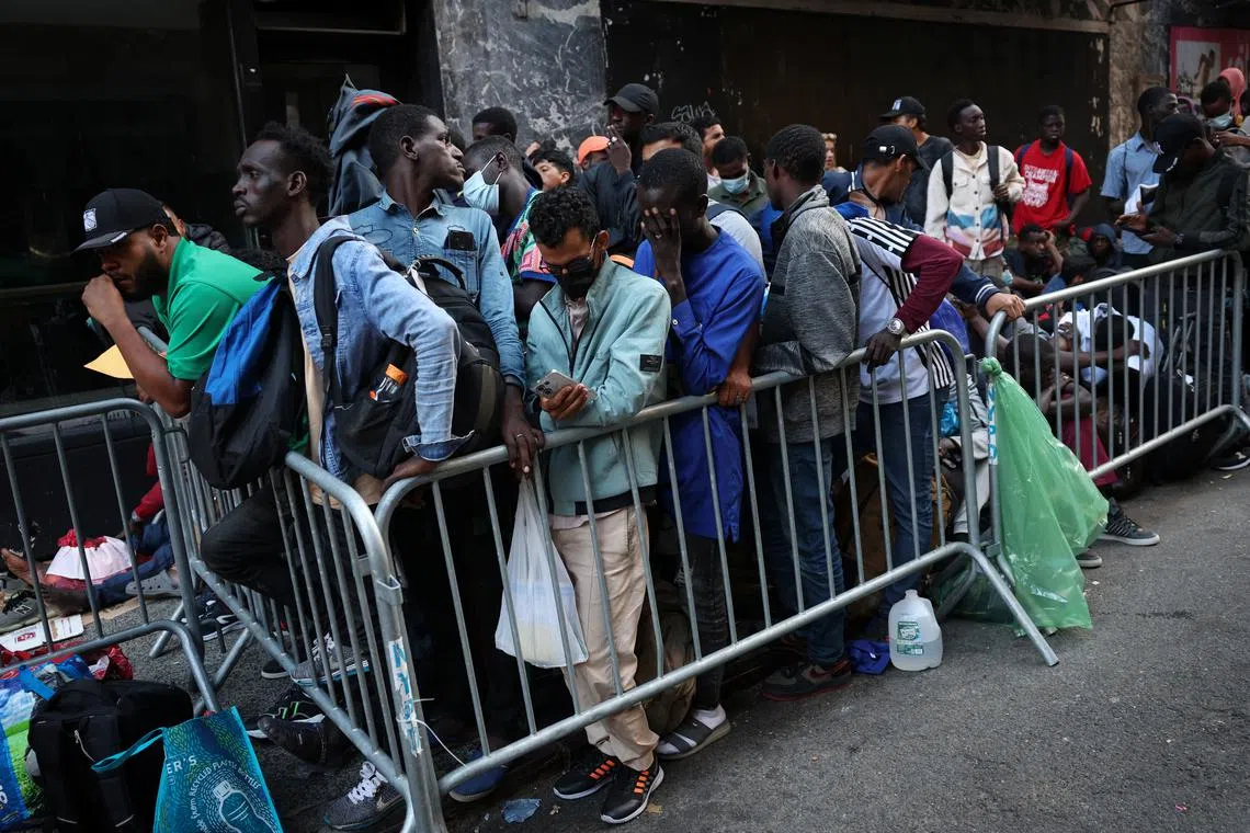 Recently arrived migrants to New York waiting outside a temporary reception centre at the Roosevelt Hotel in Manhattan on Aug 1.