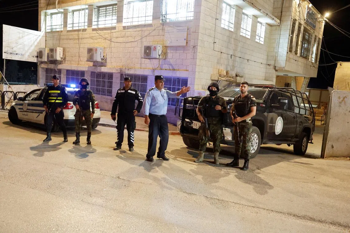 Palestinian security forces stand in the street in Tubas in the Israeli-occupied West Bank, October 21, 2024. REUTERS/Raneen Sawafta