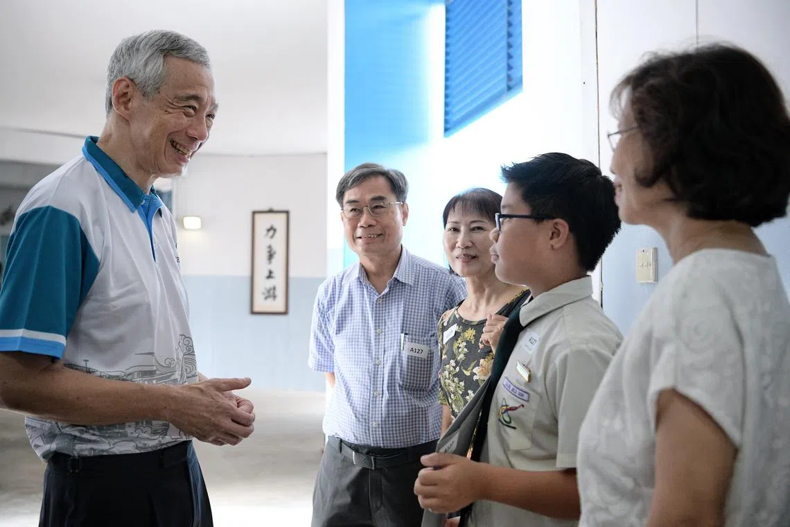 Caleb Jiele Goh, 11, Edusave Character Award recipient and his family, grandfather, copywriter  
Charlie Chan, 69,  maternal grandmother, travel consultant Sarah Chan, 60, and paternal grandmother retiree, Jemmie Goh (in white), 66
Sarah Chan, 60, mingling with PM Lee.
