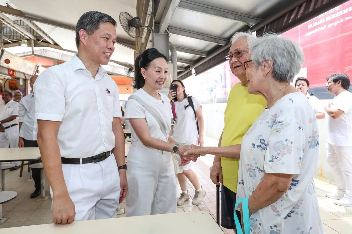Education Minister Chan Chun Sing and his fellow Tanjong Pagar GRC candidate Rachel Ong greeting residents during a walkabout in Telok Blangah Drive on April 24.