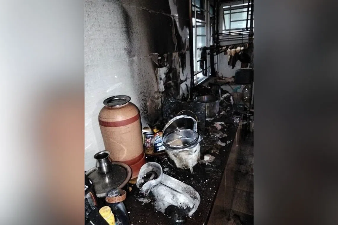 Blackened walls and deformed utensils seen in the kitchen of the flat where a fire broke out on Aug 18.