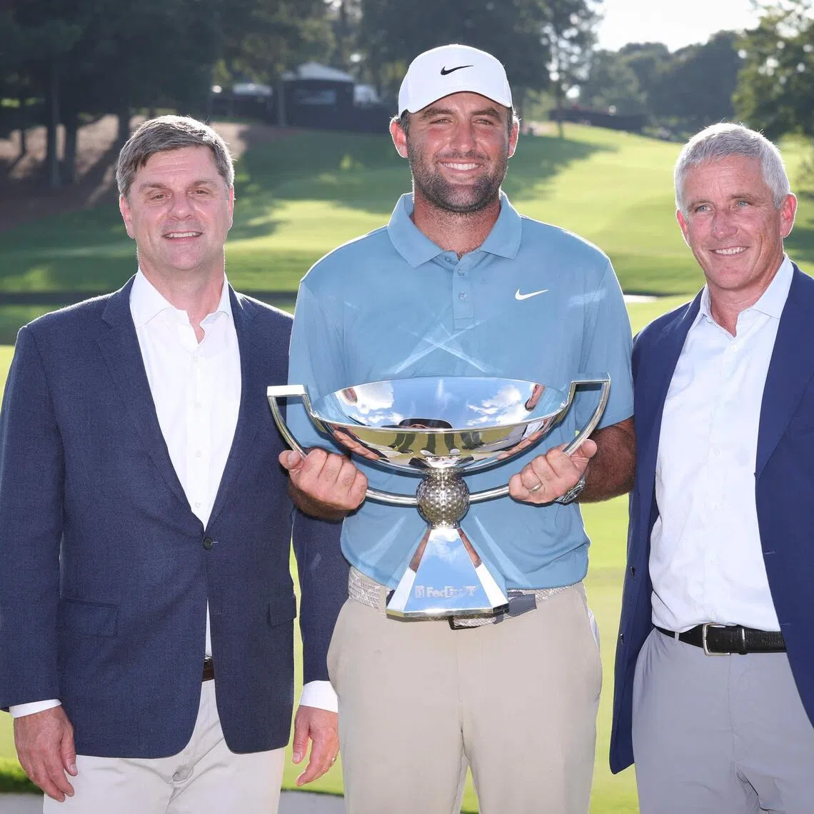 Tour Championship and FedEx Cup winner Scottie Scheffler with PGA Tour CEO Brian Rolapp (left) and commissioner Jay Monahan at East Lake Golf Club in Atlanta, Georgia on Aug 30.