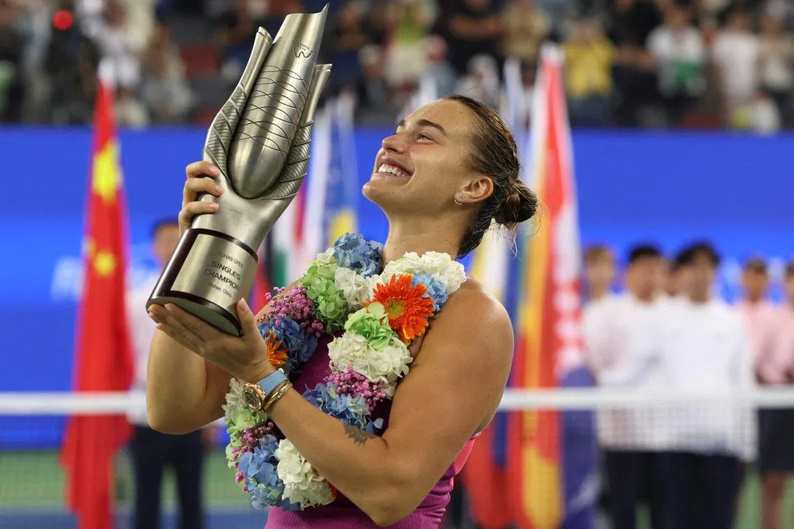 FILE PHOTO: Tennis - Wuhan Open - Optics Valley International Tennis Center, Wuhan, China - October 13, 2024  Belarus' Aryna Sabalenka celebrates with the trophy after winning her final match against China's Qinwen Zheng REUTERS/Florence Lo/File Photo