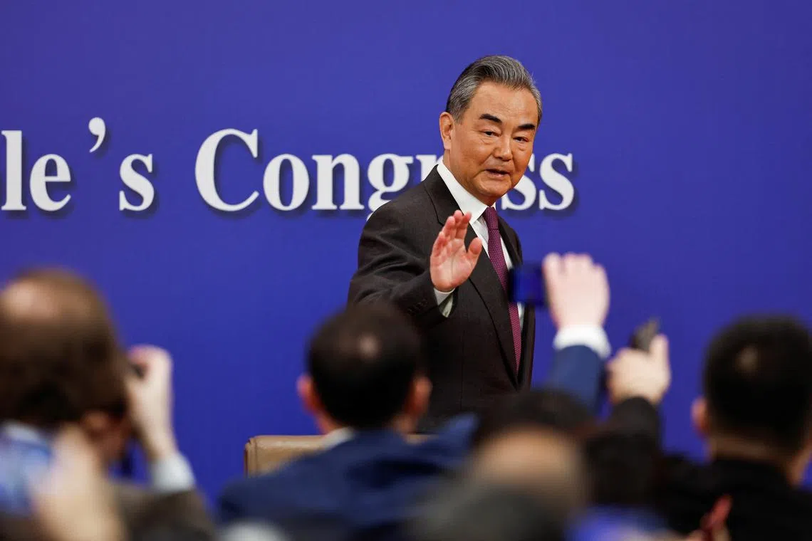 FILE PHOTO: Chinese Foreign Minister Wang Yi waves at the end of a press conference on the sidelines of the National People's Congress (NPC), in Beijing, China March 7, 2024. REUTERS/Tingshu Wang/ File photo