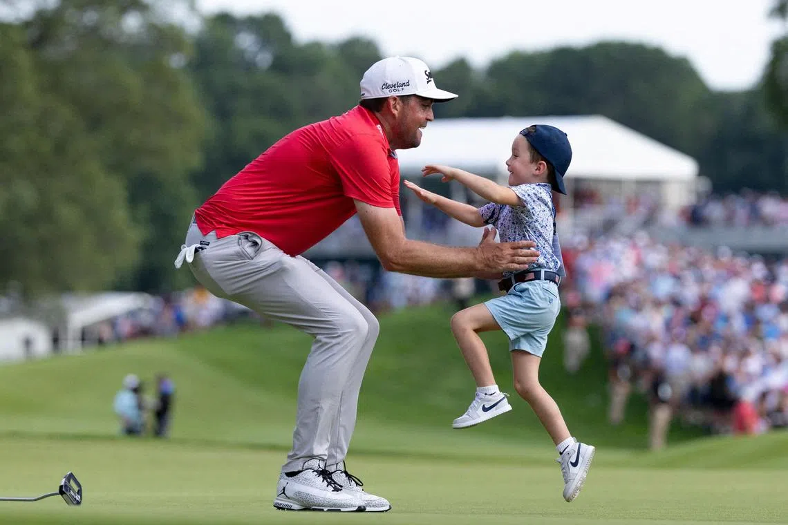 Keegan Bradley celebrates with his son Cooper after winning the Travelers Championship.