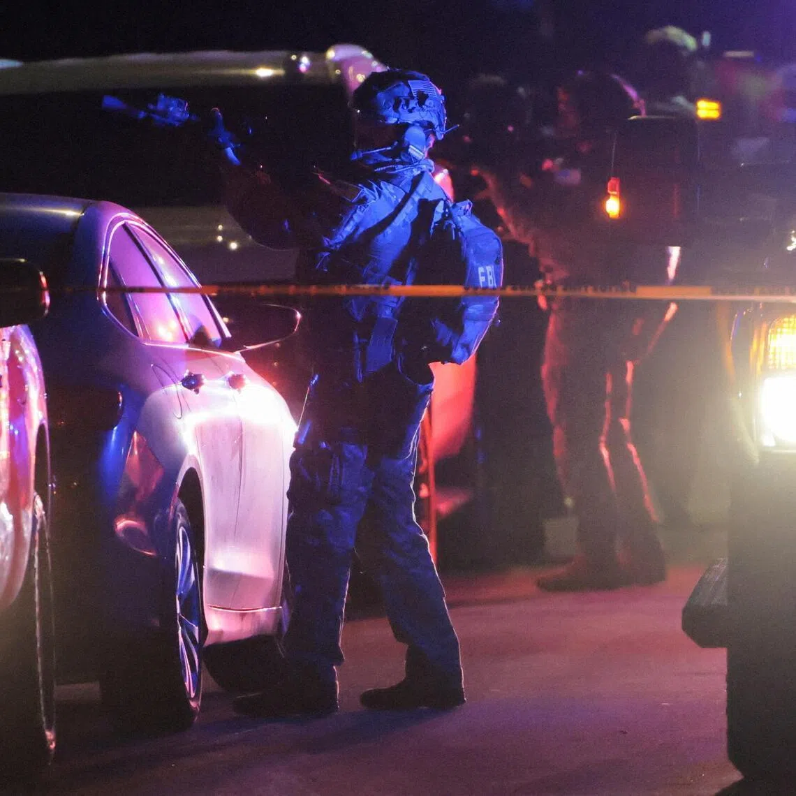 Armed FBI agents operate outside the residence associated with the suspect in the shooting incident at the annual White House Correspondents' Association dinner in Washington, D.C., on April 25, 2026. 