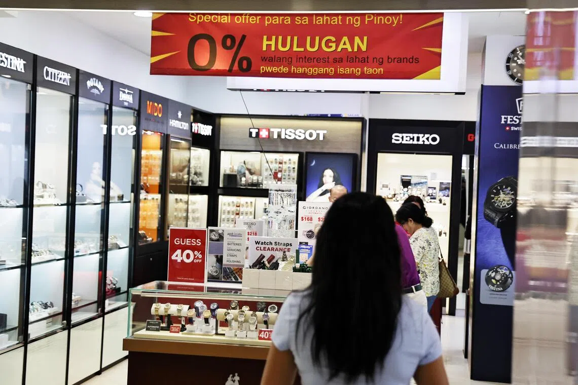 A retail shop in Lucky Plaza that offers ‘hulugan’, where a customer buys a high-ticket item by paying in installments.