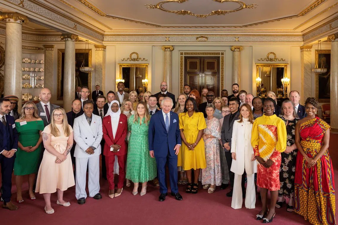 Britain's King Charles III poses for a group photo with the winners of the Prince's Trust Awards and celebrity ambassadors.