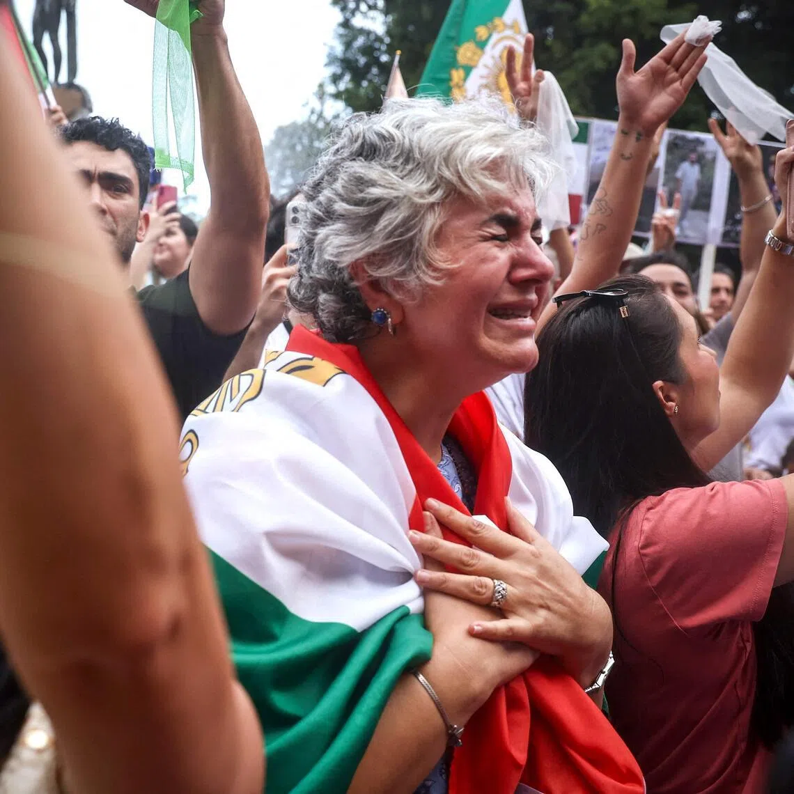A woman cries as she stands with other members of the Iranian community during a rally in Sydney on March 1.