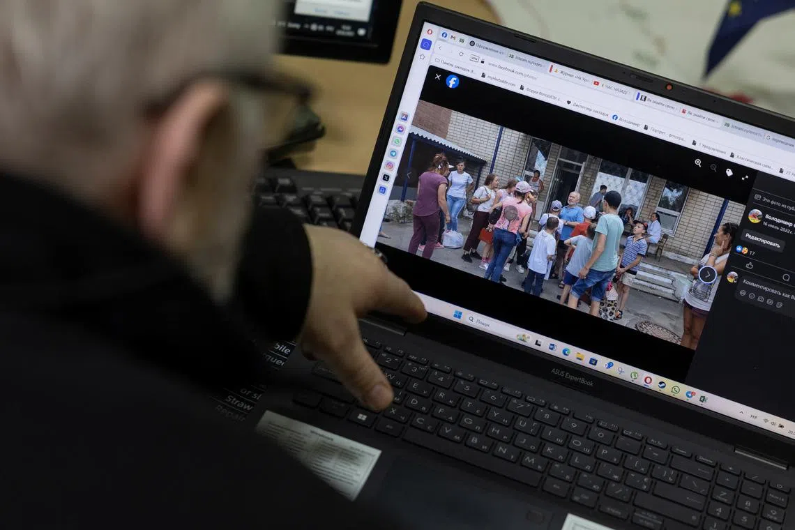 Volodymyr Sahaidak, head of Kherson regional children's centre of social and psychological rehabilitation, shows a picture on his Facebook page where he was photographed with children during a Russian occupation, amid Russia's attack on Ukraine, in outskirts of Kherson, Ukraine March 20, 2025. REUTERS/Valentyn Ogirenko