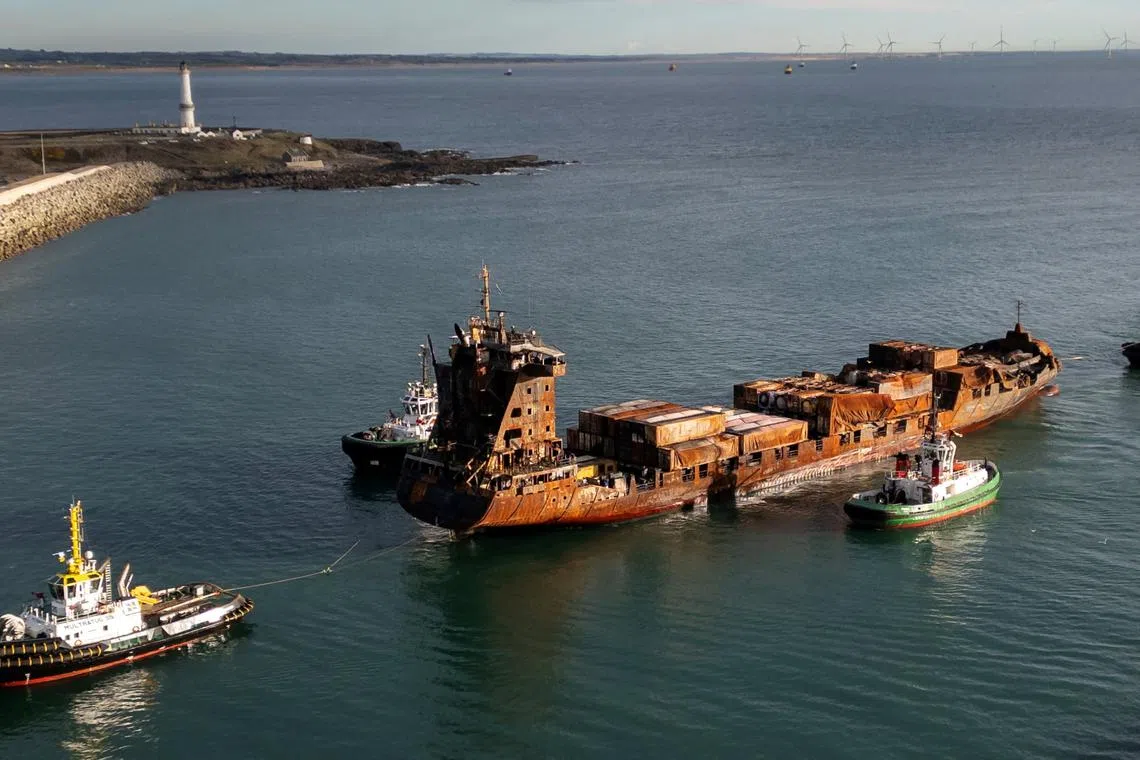 A drone view shows the container ship Solong, damaged as a result of colliding with the anchored Stena Immaculate oil tanker ship, towed by tug boats into the port of Aberdeen, Scotland, Britain, March 28, 2025. REUTERS/Phil Noble/ File Photo