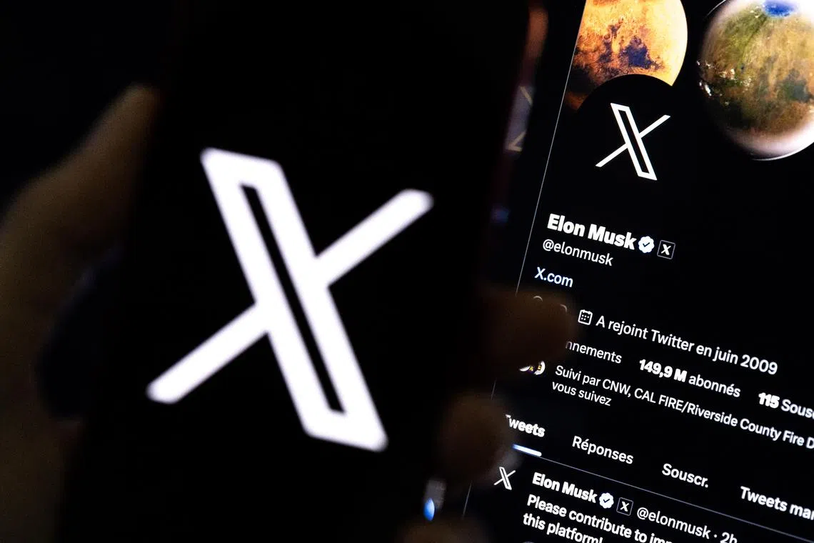 epa10772438 An illustration pictures shows a user holding a mobile phone displaying the 'X' logo in front of Elon Musk's page in Los Angeles, California, USA, 27 July 2023. Twitter announced on 23 July that it will rebrand to X.  EPA-EFE/ETIENNE LAURENT