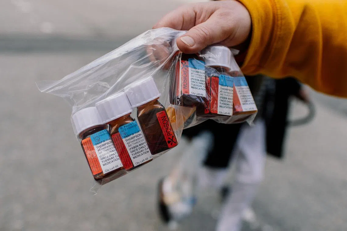 A recovering heroin addict who said that harm reduction services saved his life, shows his methadone prescription, in Vancouver on April 30.