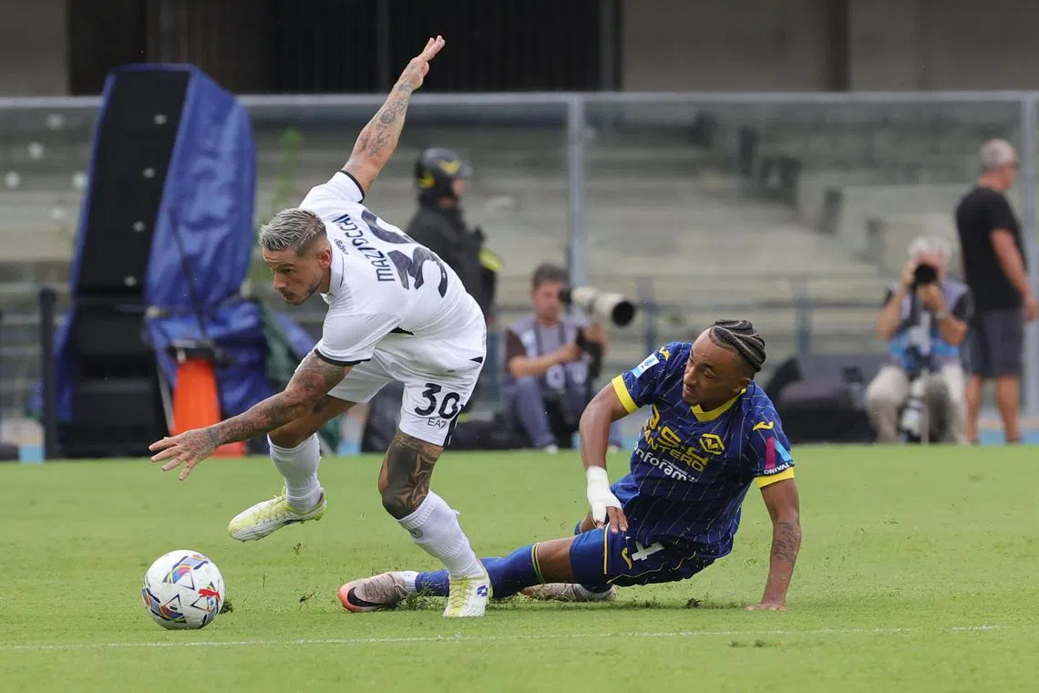 Hellas Verona's Dailon Livramento tackling Napoli's Pasquale Mazzocchi in their Italian Serie A soccer match at the Marcantonio Bentegodi stadium in Verona, Italy on Aug 18, 2024.