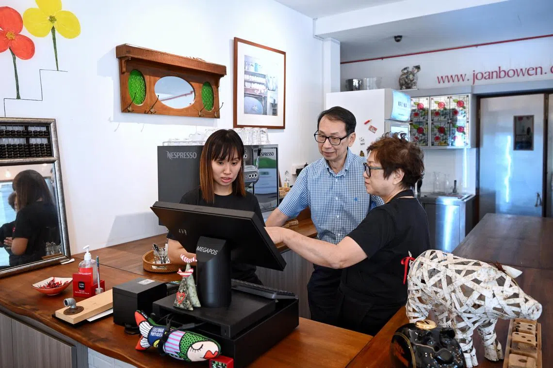 ST20230405_202349163134 Kua Chee Siong/ sfspecial/ Mr Khong Yoon Kay (centre) and Mrs Jeanne Seah-Khong (right) set up a cafe for their daughter Joan Bo-Wen Khong (left) at the Joan Bowen cafe to give her meaningful employment and social engagement.