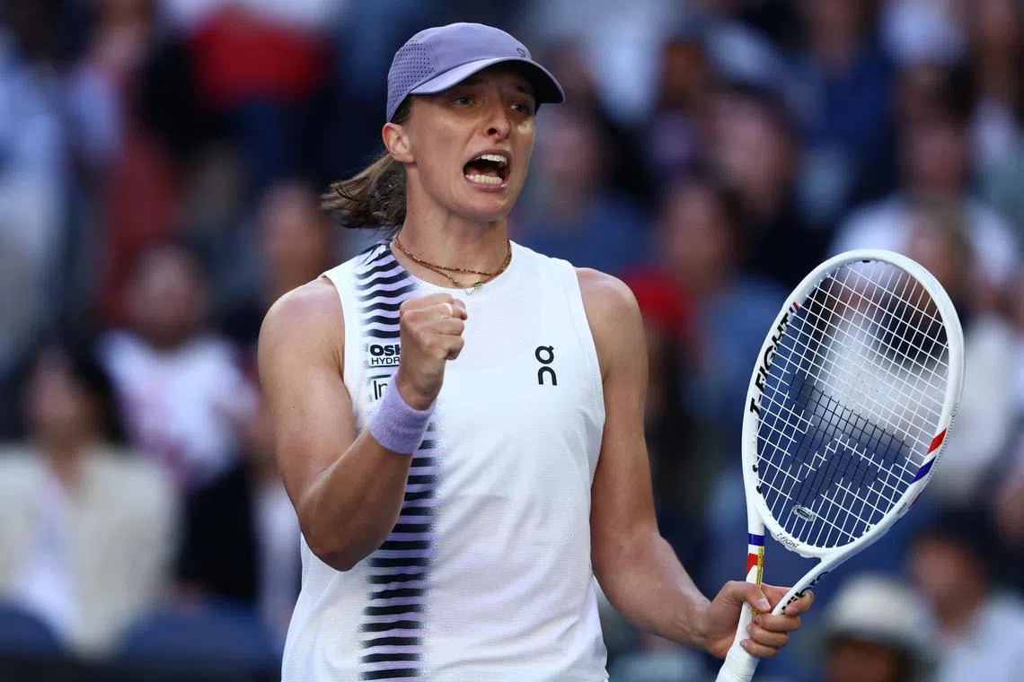 Tennis - Australian Open - Melbourne Park, Melbourne, Australia - January 22, 2026 Poland's Iga Swiatek celebrates after winning her second round match against Czech Republic's Marie Bouzkova REUTERS/Tingshu Wang