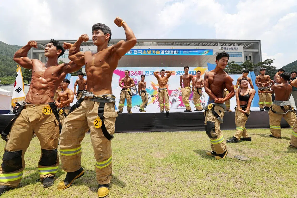 Firefighters taking part in the bodybuilding event during a firefighting skills contest at the National Fire Service Academy in Gongju, South Korea on June 13, 2023.  