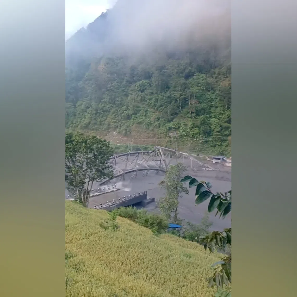 Floodwaters wash away the collapsed Soti Bridge on Budhi Gandaki River, in Chumnubri village, in Gorkha District, Nepal, on Oct 11.