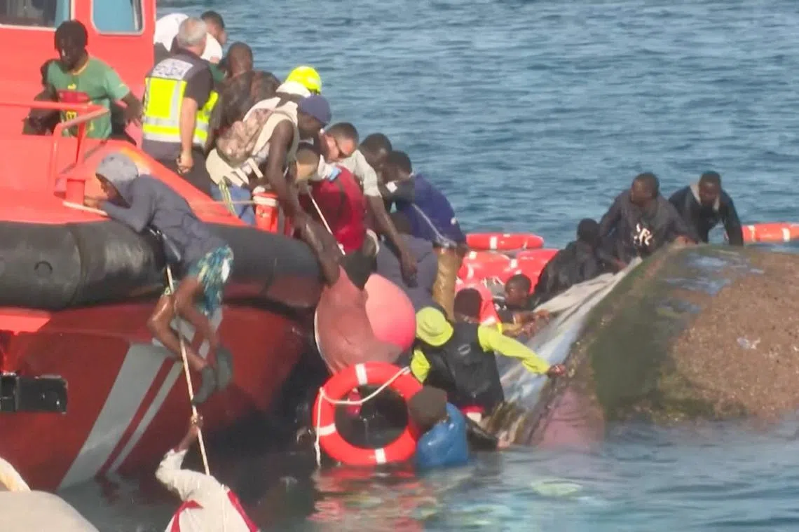 A view shows emergency services trying to rescue migrants from the water, as a migrant boat capsized as rescuers were escorting it to port in Spain's Canary Islands, in La Restinga, Spain May 28, 2025, in this screengrab obtained from a video. FORTA/Handout via REUTERS