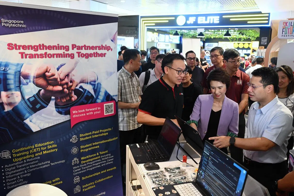 South West District Mayor Low Yen Ling (2nd from right) and Education Minister Desmond Lee (right) with residents at the SkillsFuture Festival @ South West in Westgate on Oct 16.