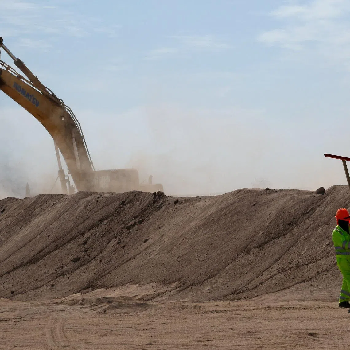 A worker walks near a trench dug by heavy machinery as Chilean President Jose Antonio Kast launches the \"Border Shield\" plan in Arica, near the border with Peru, as part of a crackdown on illegal immigration, Chile March 16, 2026. REUTERS/Alexander Infante