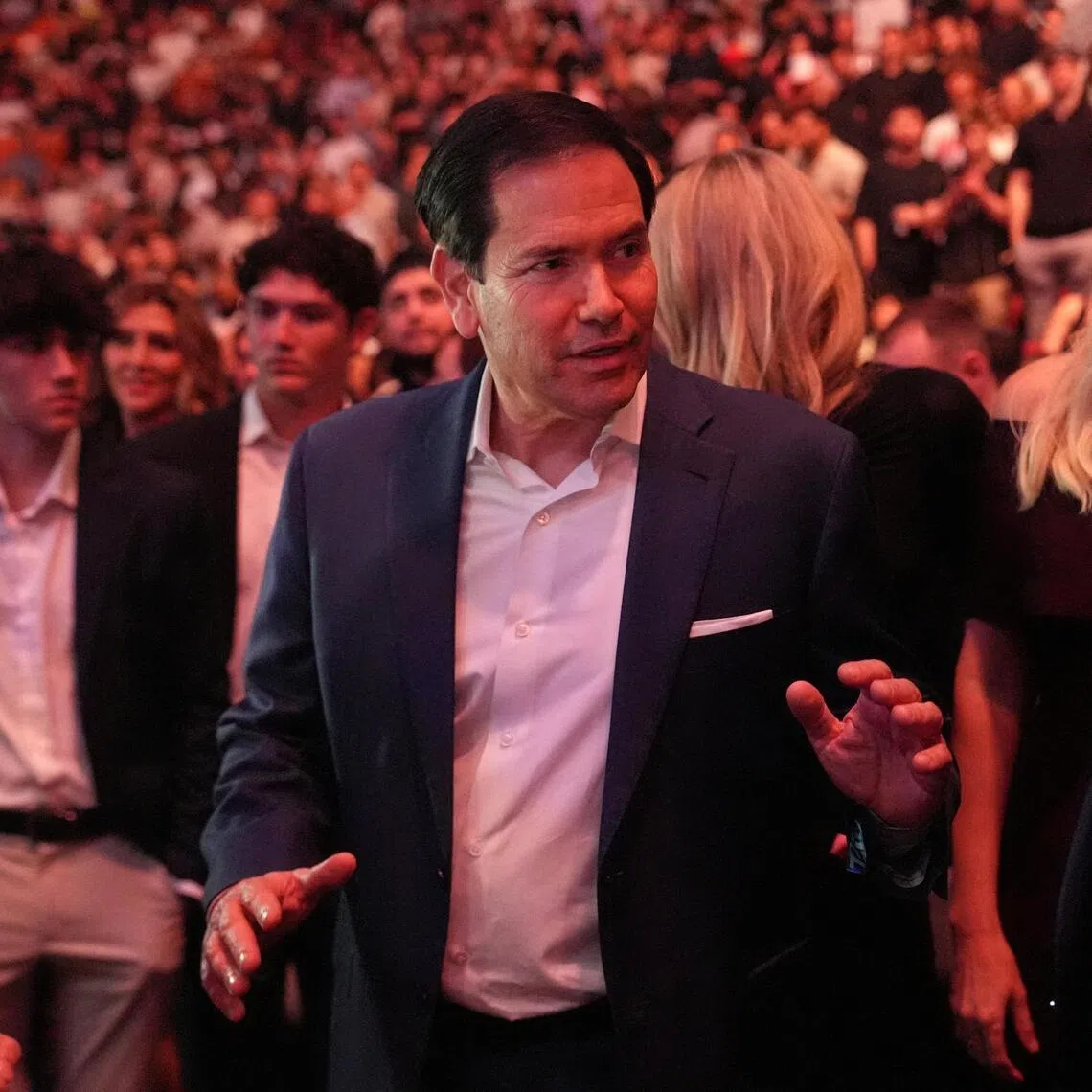 US President Donald Trump talks to  Secretary of State Marco Rubio while attending UFC 327 at Kaseya Center in Miami on April 11, 2026.