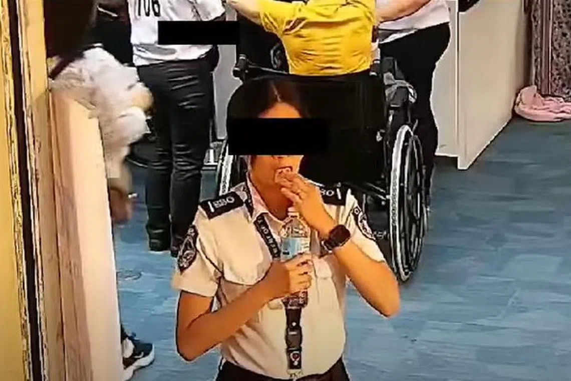 A screening officer at Manila's airport can be seen in this screenshot swallowing US$300 worth of bills.