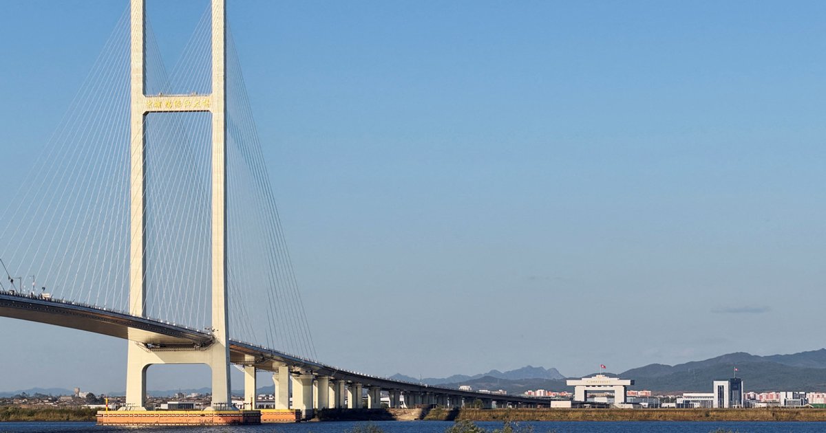 Trucks line up as long-delayed China-North Korea bridge officially opens