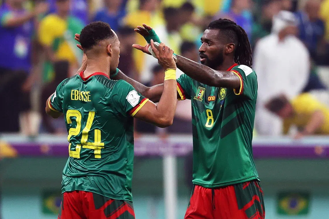 Cameroonian players Enzo Ebosse (left) and Andre-Frank Zambo Anguissa celebrate beating Brazil, despite not going through.