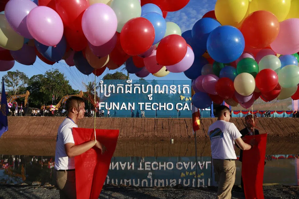 Cambodian officers hold balloons at the construction site of the Funan Techo canal along the Prek Takeo channel in Kandal province, Cambodia, on Aug 5, 2024. 