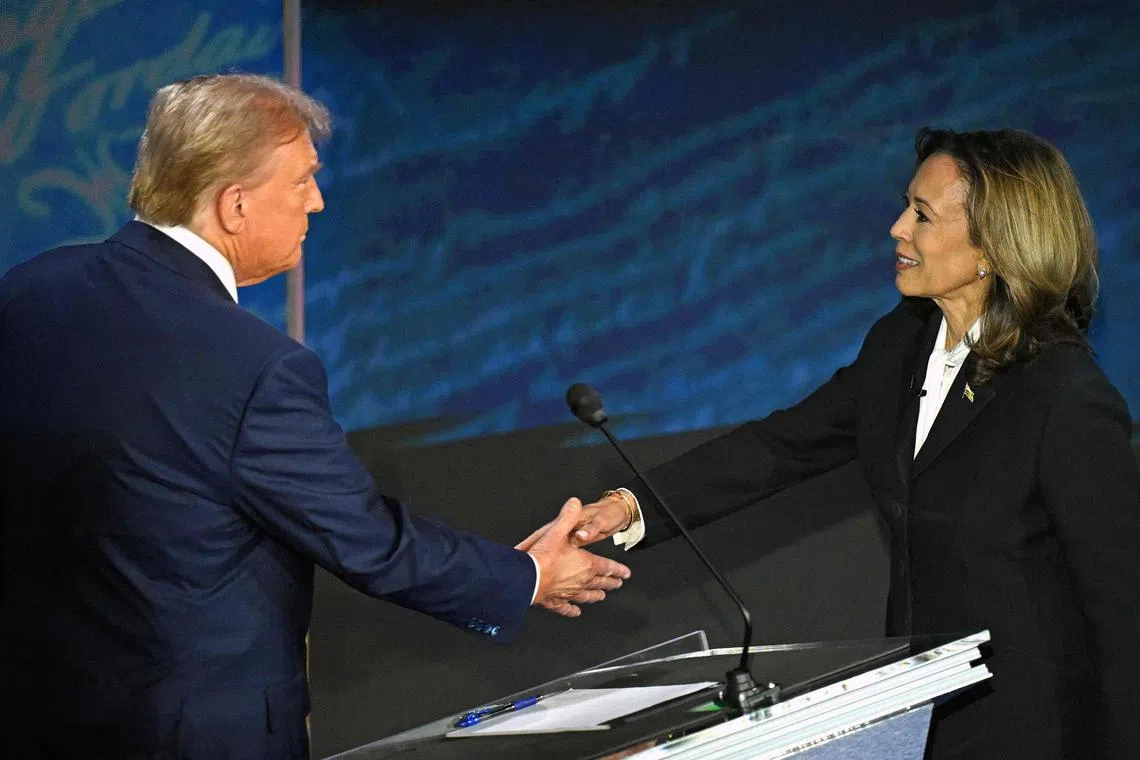 US Vice President and Democratic presidential candidate Kamala Harris (R) shakes hands with former US President and Republican presidential candidate Donald Trump during a presidential debate at the National Constitution Center in Philadelphia, Pennsylvania, on September 10, 2024. (Photo by SAUL LOEB / AFP)