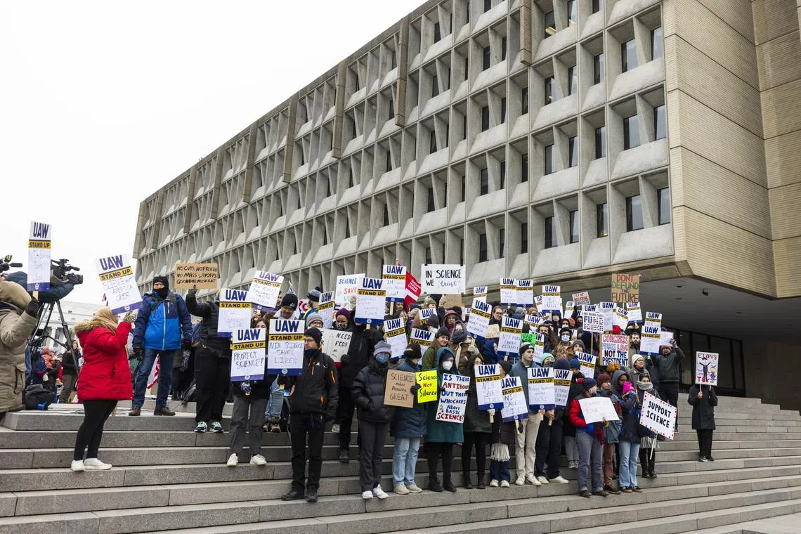 Researchers, academics and protesters rally outside the Health and Human Services Building against funding freezes on research and higher education in Washington, on Feb 19.