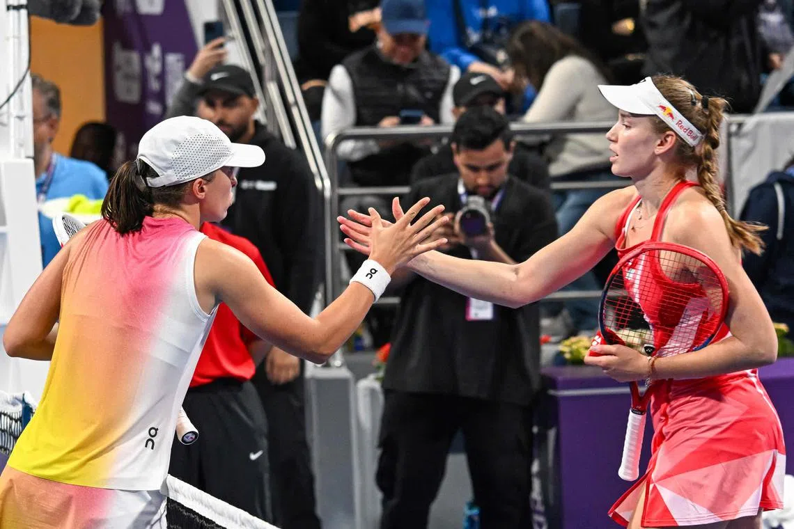 Poland's Iga Swiatek (left) greeting Kazakhstan's Elena Rybakina after winning the 2025 WTA Qatar Open quarter-final tennis match at the Khalifa International Tennis Complex in Doha on Feb 13.