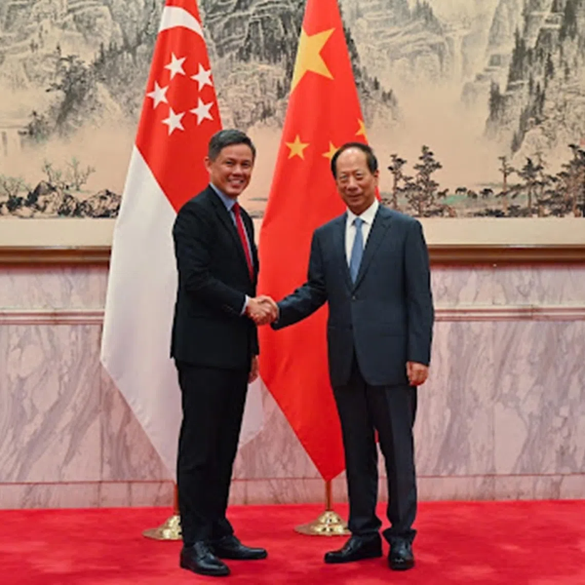 Defence Minister Chan Chun Sing with Mr Shi Taifeng , a member of the Political Bureau of the Communist Party of China (CPC) and Minister of the CPC Central Committee Organisation Department, in Beijing, on Sept 17.