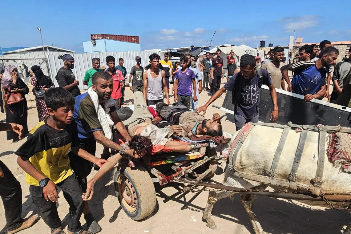 Injured Palestinians are taken to a Red Cross clinic in Rafah, in the southern Gaza Strip, after they were reportedly shot while waiting to receive food parcels at an aid distribution point on July 12.