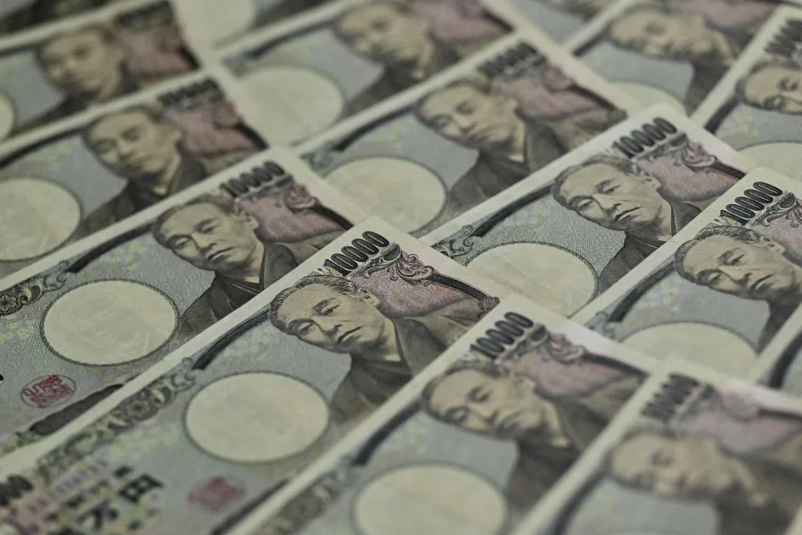 This photo illustration taken on September 24, 2022 shows Japanese 10,000 yen notes on display in Tokyo. 
